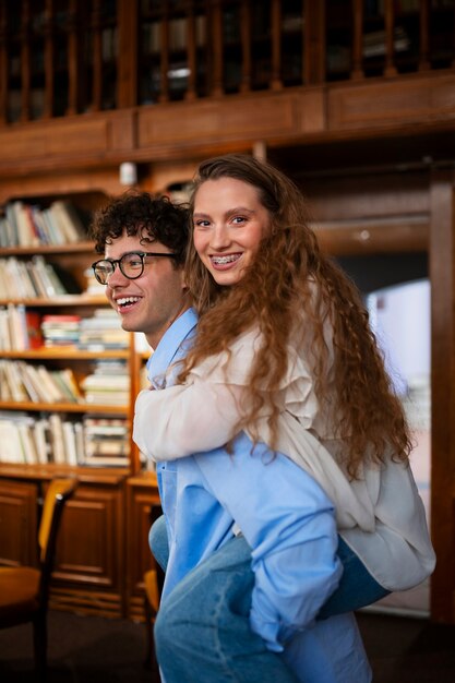 Medium shot couple having a bookstore date