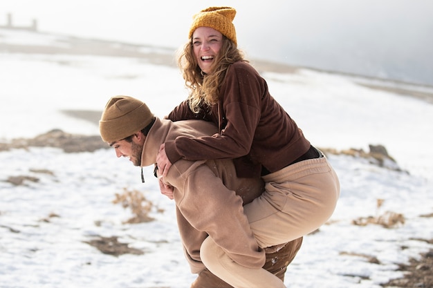 Medium shot couple having fun outdoors