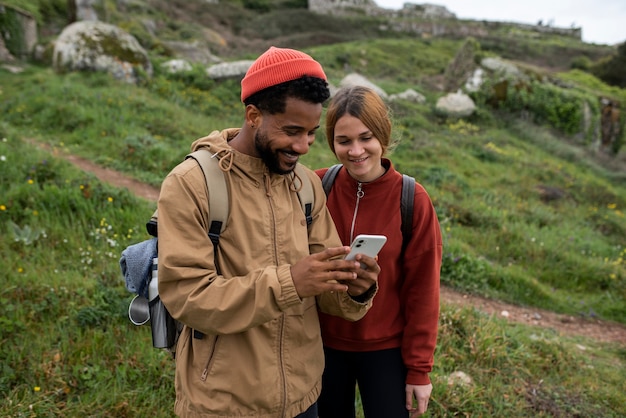 Medium shot couple hiking together