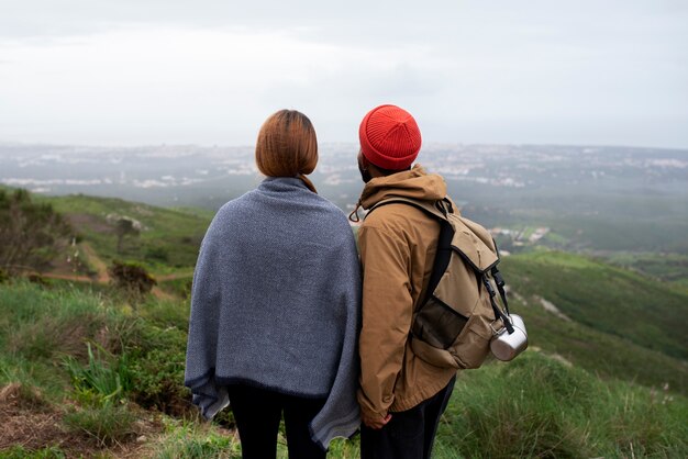 Medium shot couple hiking together