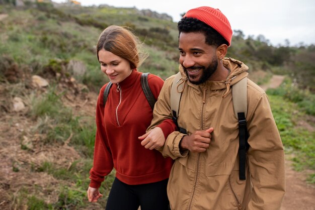 Medium shot couple hiking together