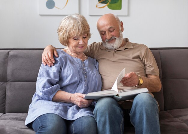 Medium shot couple holding book