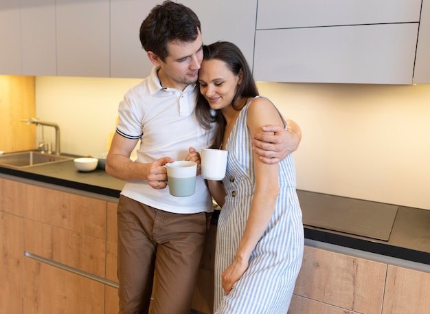 Free photo medium shot couple holding cups