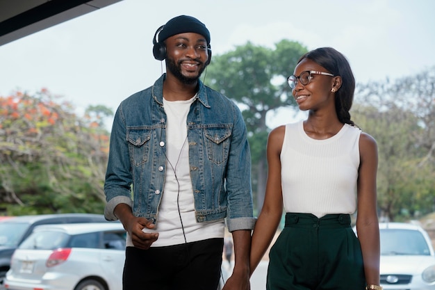 Medium shot couple holding hands outdoors