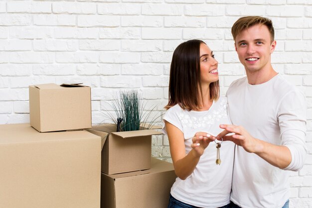 Medium shot couple holding keys