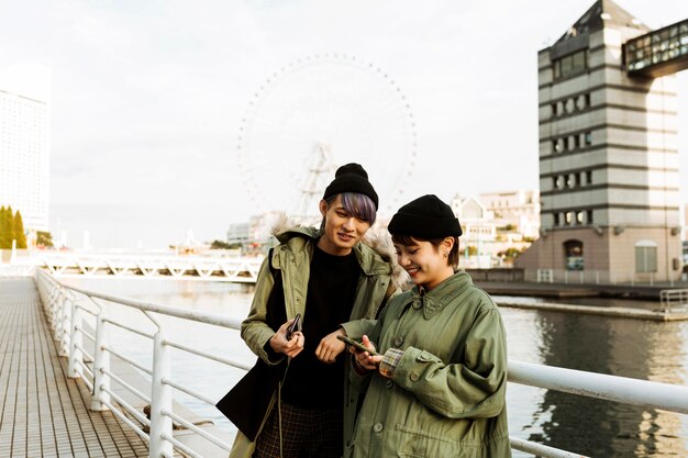 Medium shot couple holding phones