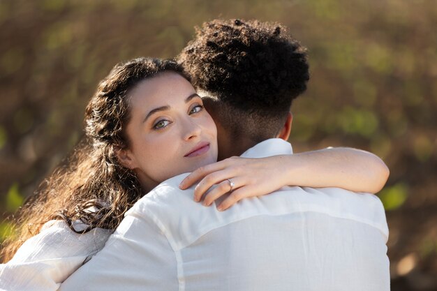 Medium shot couple hugging outdoors