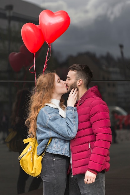 Free photo medium shot of couple kissing