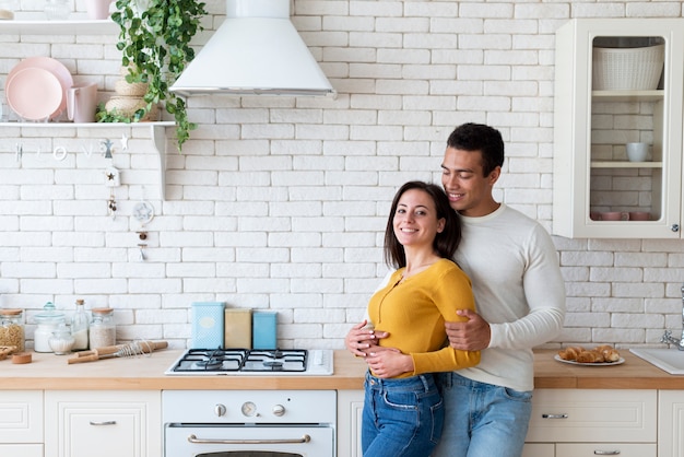 medium shot of couple in kitchen