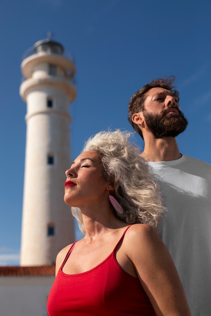 Free photo medium shot couple at the lighthouse