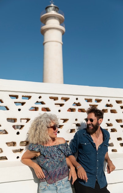 Free photo medium shot couple at the lighthouse