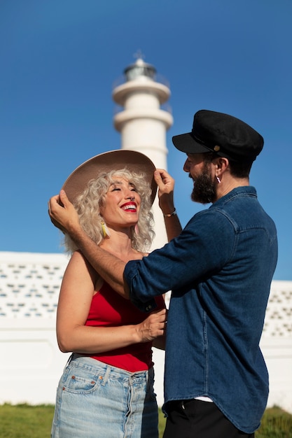 Free photo medium shot couple at the lighthouse