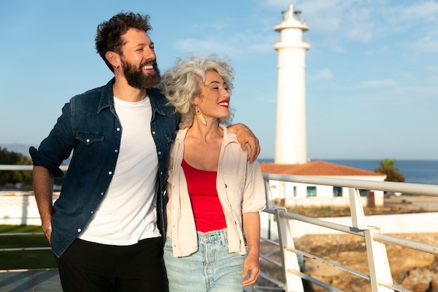 Free photo medium shot couple at the lighthouse