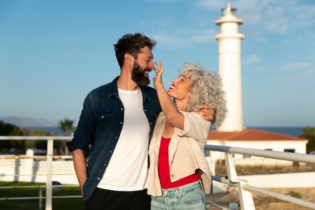 Free photo medium shot couple at the lighthouse