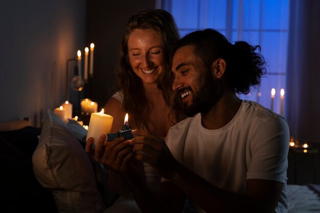 Medium shot couple lighting candle