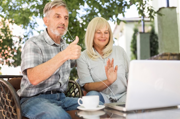 Medium shot couple looking at laptop