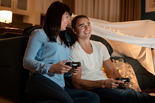 Medium shot couple playing video games