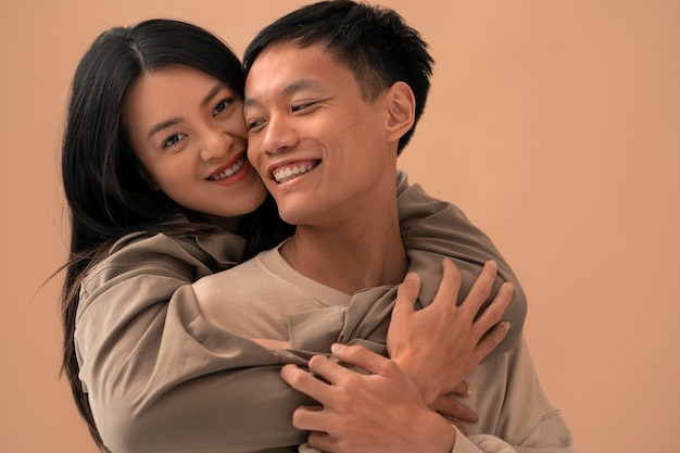 Medium shot couple posing in studio