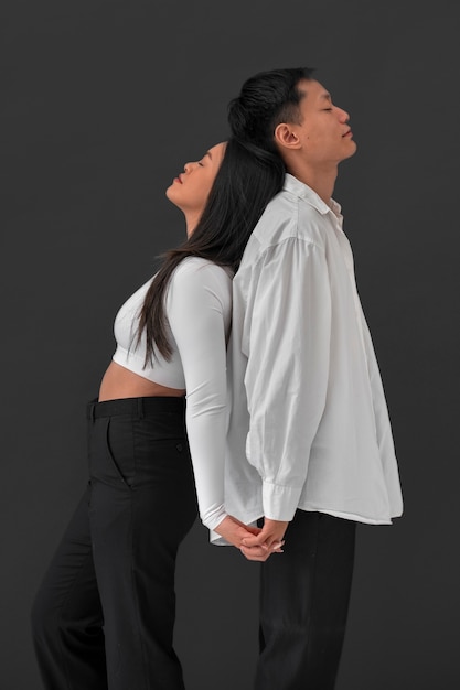 Medium shot couple posing in studio