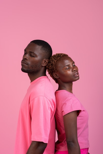 Free photo medium shot couple posing with pink outfit