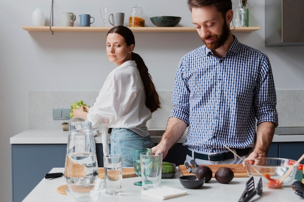 Free photo medium shot couple preparing delicious food