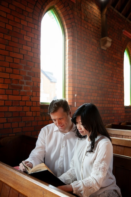 Medium shot couple reading bible