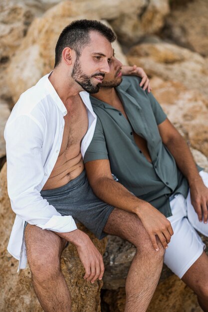 Medium shot couple sitting on rocks