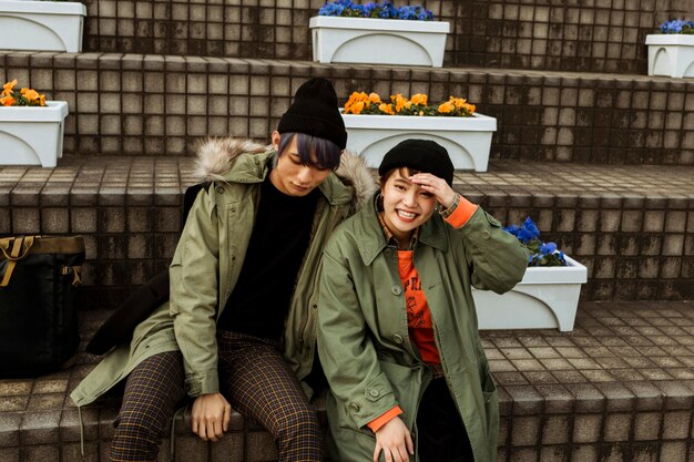 Medium shot couple sitting on stairs