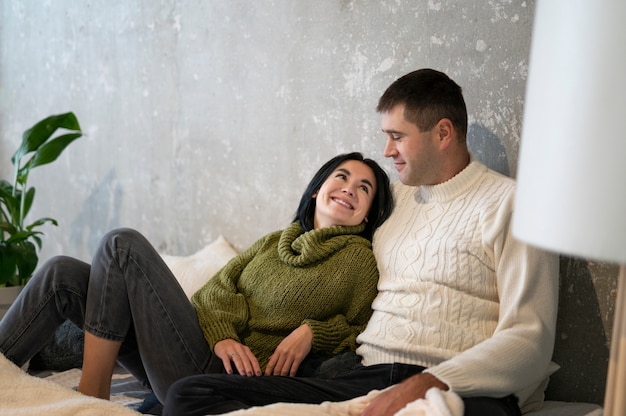 Free photo medium shot couple sitting together