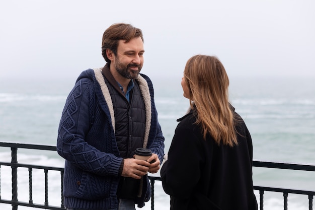 Medium shot couple spending time at seaside