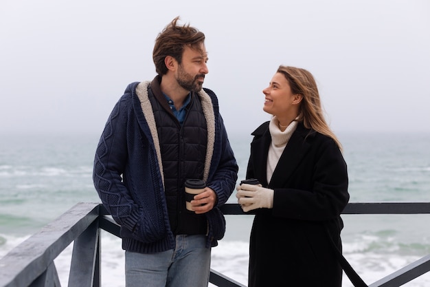 Free photo medium shot couple spending time at seaside