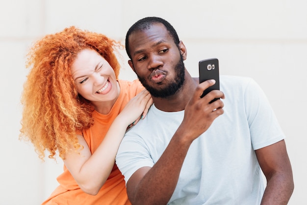 Medium shot of couple taking a selfie