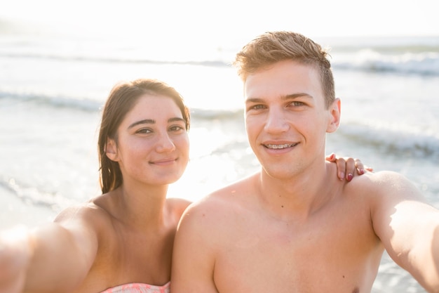 Medium shot couple taking selfie