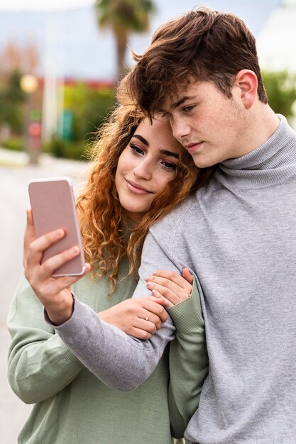 Medium shot couple taking selfie