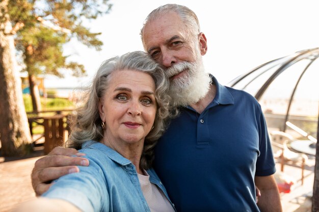 Medium shot couple taking selfie