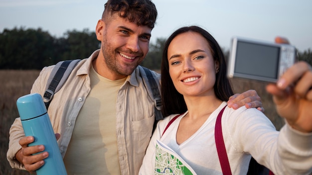 Medium shot couple taking selfies