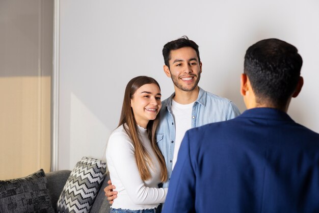 medium shot couple talking to real estate agent