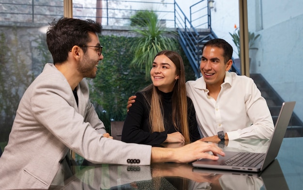 Medium shot couple talking to real estate agent