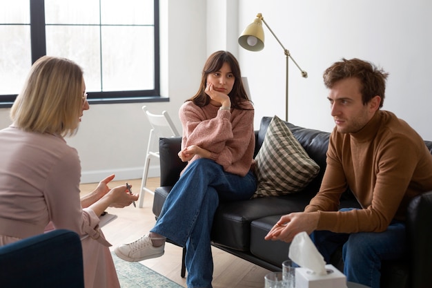 Medium shot couple undergoing therapy