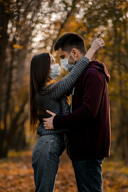 Medium shot couple wearing medical mask