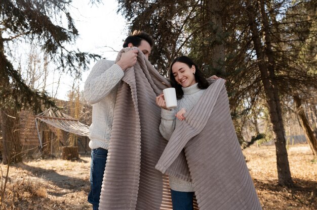 Medium shot couple with big blanket