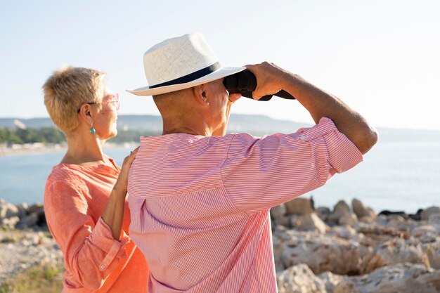 Medium shot couple with binoculars