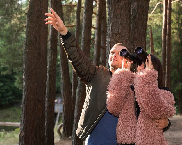 Medium shot couple with binoculars