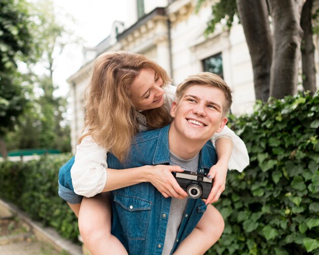 Medium shot couple with camera posing