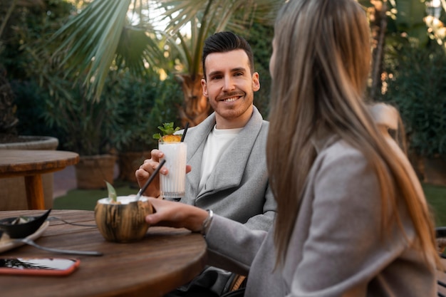 Medium shot couple with pina colada