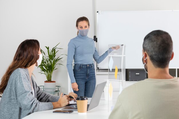 medium shot coworkers in meeting