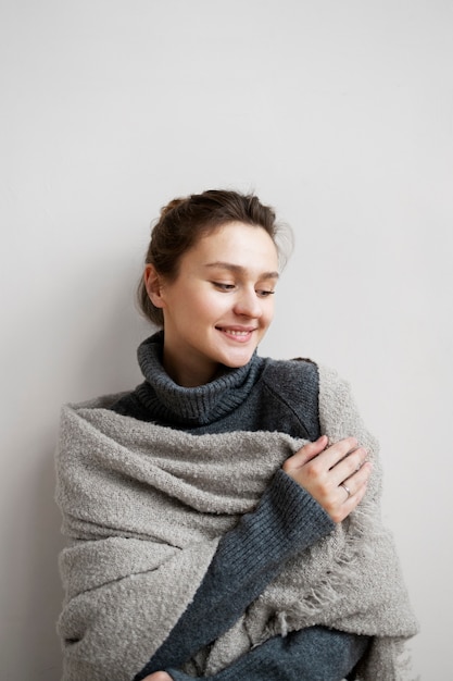 Medium shot cozy smiley woman at home