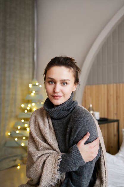 Medium shot cozy woman with blanket