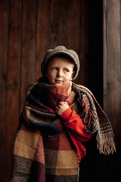 Medium shot cute boy with scarf and hat