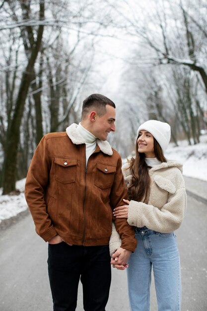 medium shot cute couple holding hands